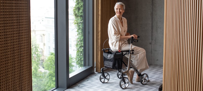 Lady Using the Rehasense Space LX Lightweight Rollator (Electric Blue)