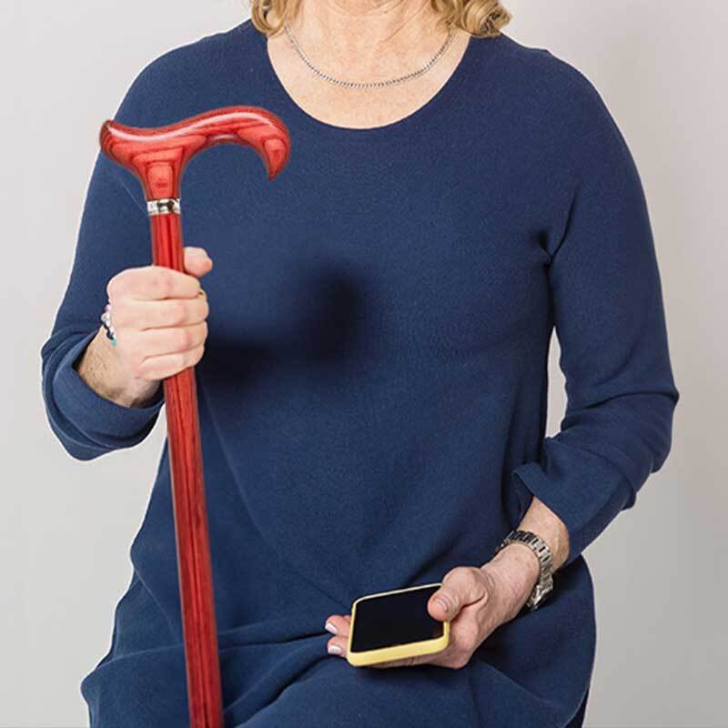 a woman in a dark blue shirt holding a red walking stick