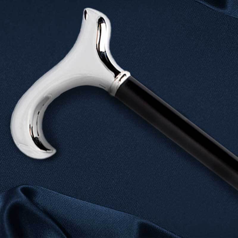 a black walking stick with a silver handle against navy material