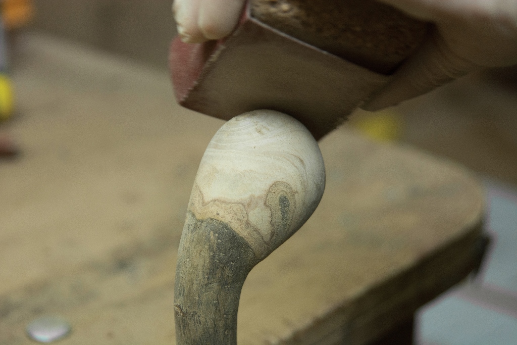 Sanding an ash walking stick