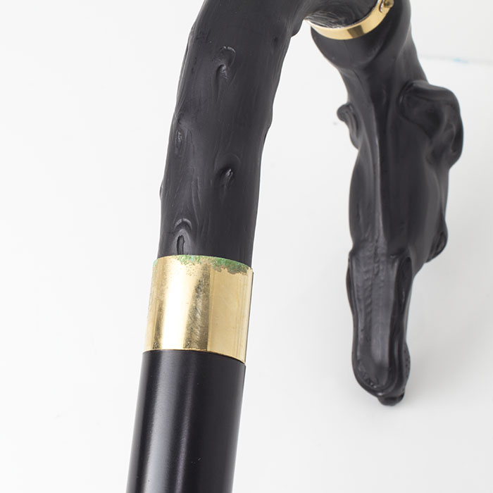 This cane features slight damage to the metal collar